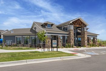 a large building with a parking lot and a street in front of it  at Watermark at Harvest Junction, Longmont